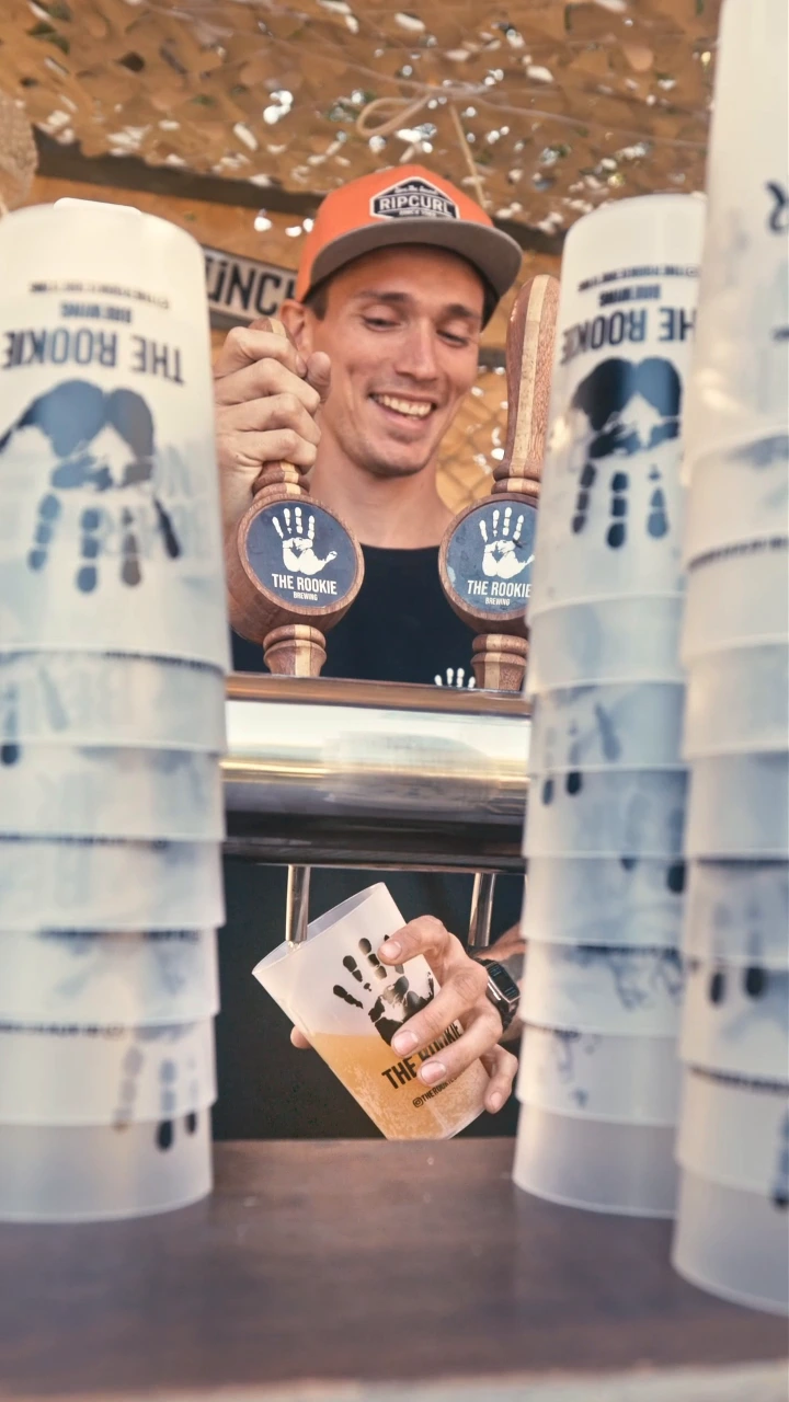 The Rookie brewer pouring beer between branded tap handles